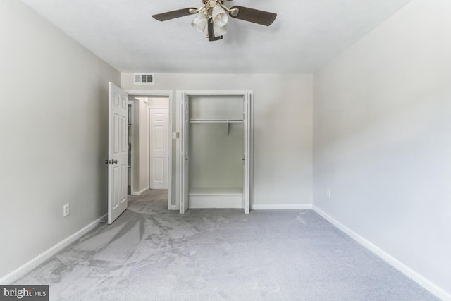 unfurnished bedroom featuring a closet, ceiling fan, and light colored carpet