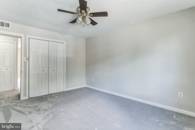 unfurnished bedroom with carpet flooring, a closet, and ceiling fan