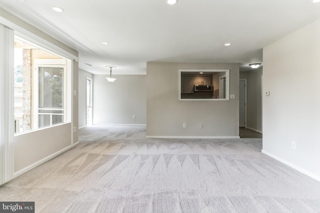 unfurnished room with light carpet