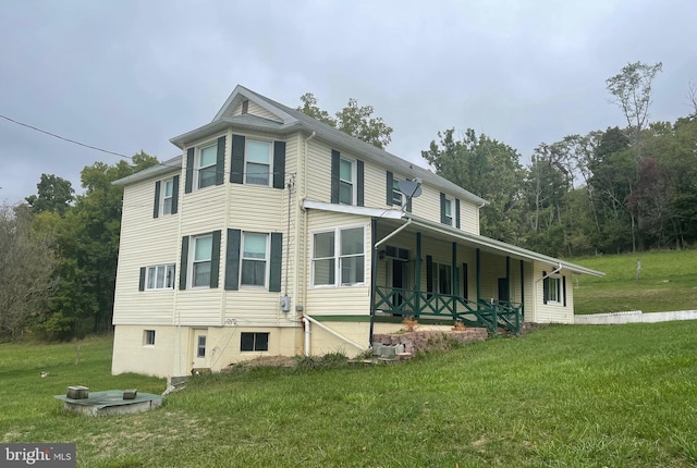 view of home's exterior featuring covered porch and a yard