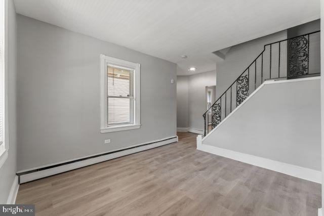 empty room featuring light hardwood / wood-style flooring and baseboard heating