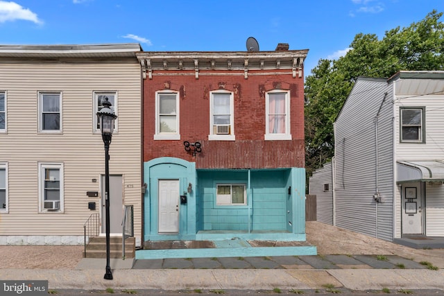 view of property with entry steps and brick siding