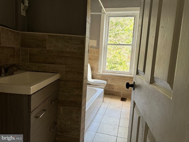 full bathroom featuring a tub to relax in, tile walls, vanity, and tile patterned floors