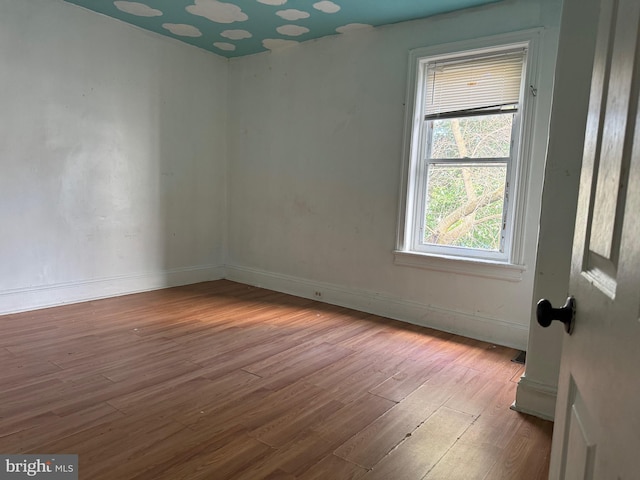 empty room featuring light wood-type flooring and baseboards