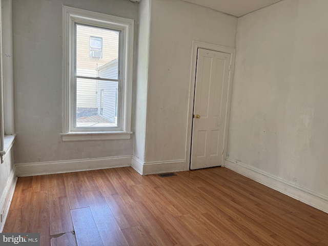 empty room featuring light wood-style flooring and baseboards