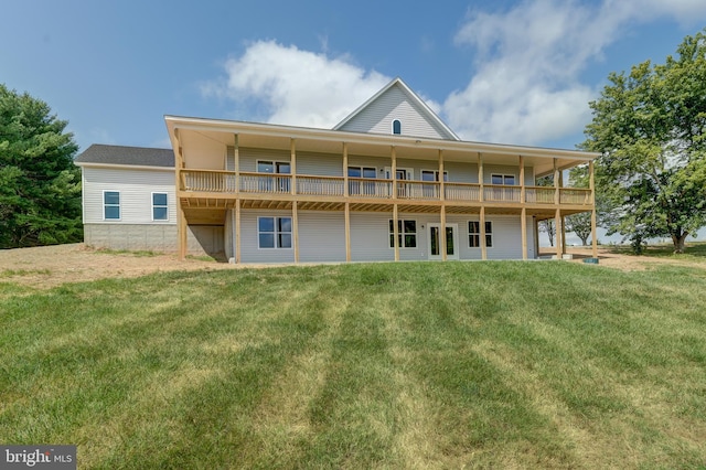 back of house featuring a lawn and a wooden deck