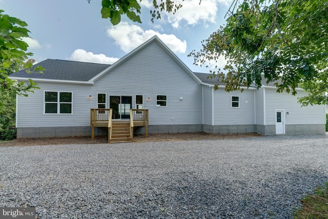 back of property featuring a wooden deck