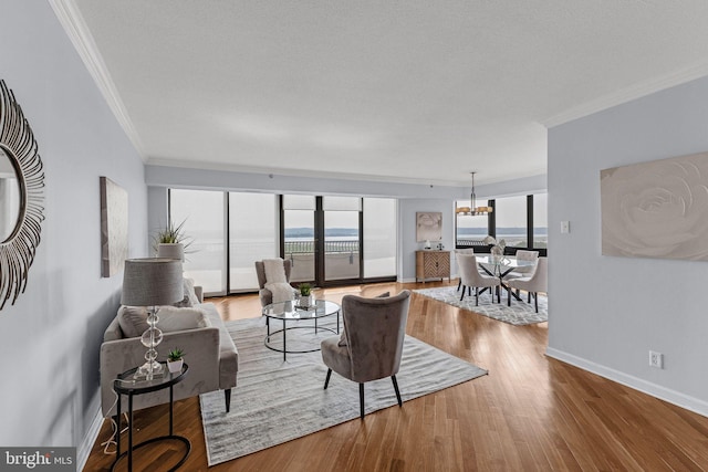 living room featuring a notable chandelier, plenty of natural light, and hardwood / wood-style floors