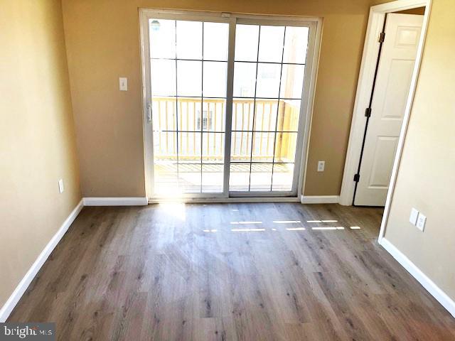 unfurnished room with wood-type flooring