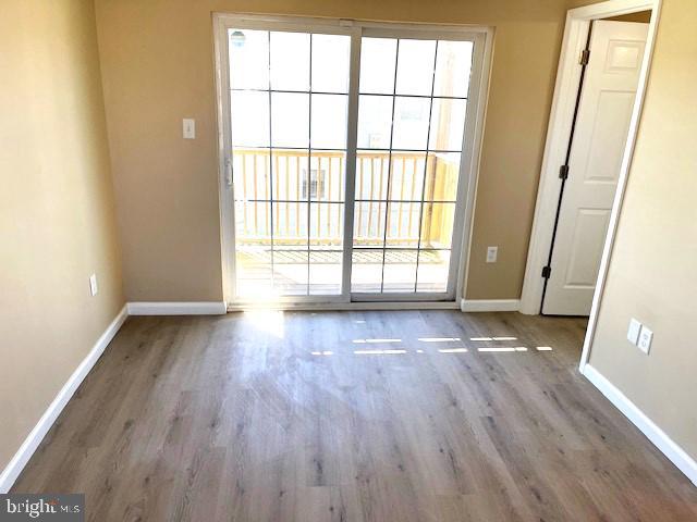 empty room with light hardwood / wood-style floors