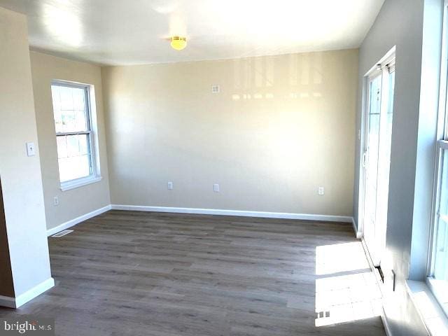 spare room with dark hardwood / wood-style floors