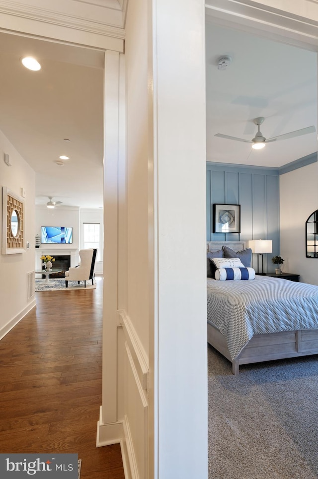 bedroom with ceiling fan and wood-type flooring