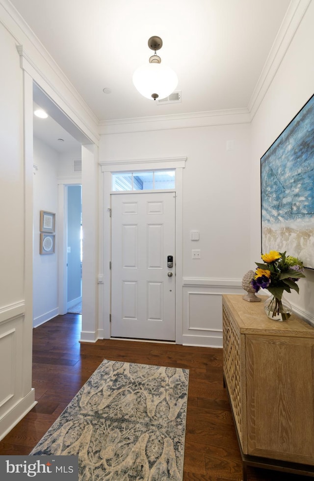 foyer featuring dark hardwood / wood-style floors and ornamental molding