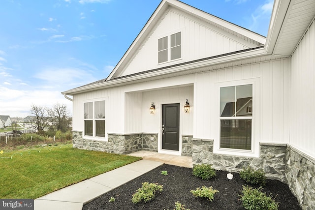 property entrance with a lawn