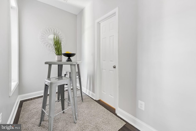 hall with dark wood-type flooring