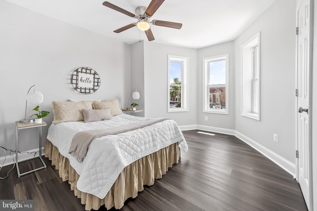 bedroom with dark hardwood / wood-style floors and ceiling fan