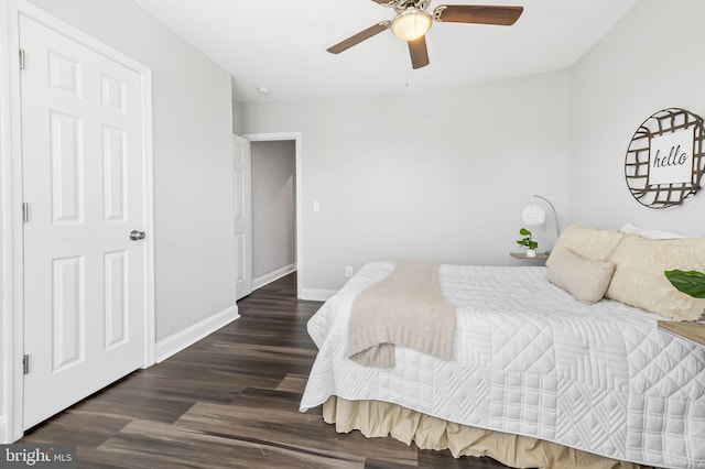 bedroom with ceiling fan and dark hardwood / wood-style floors