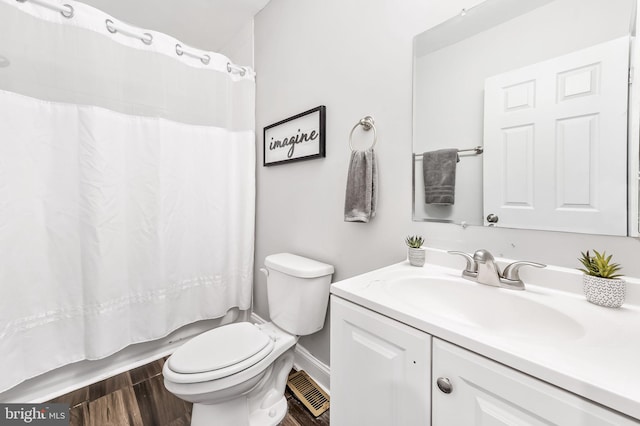 full bathroom featuring vanity, toilet, wood-type flooring, and shower / tub combo with curtain