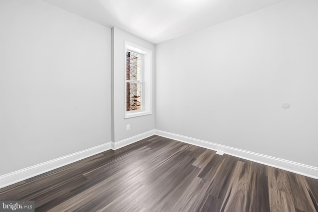 spare room featuring dark hardwood / wood-style floors