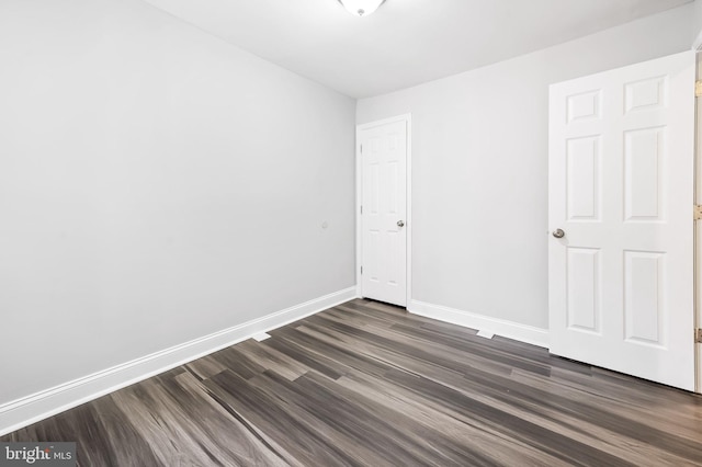 spare room with dark hardwood / wood-style flooring