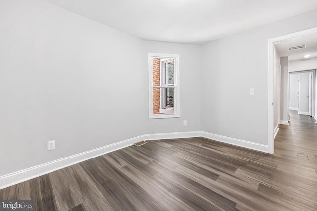 empty room with dark wood-type flooring