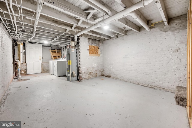 basement with electric water heater and washer and dryer