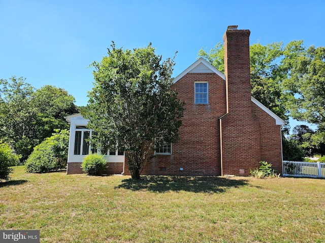 view of side of property with a yard