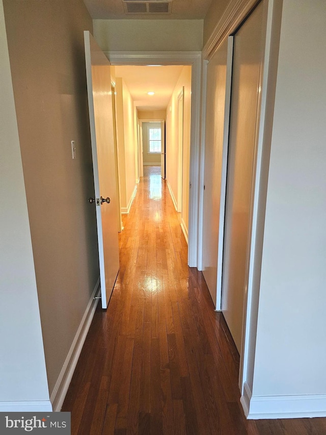 hall with hardwood / wood-style floors