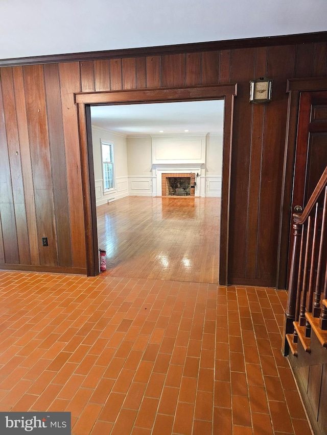 hallway with hardwood / wood-style floors and wooden walls