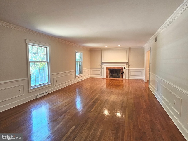 unfurnished living room featuring ornamental molding, dark wood-type flooring, and a fireplace