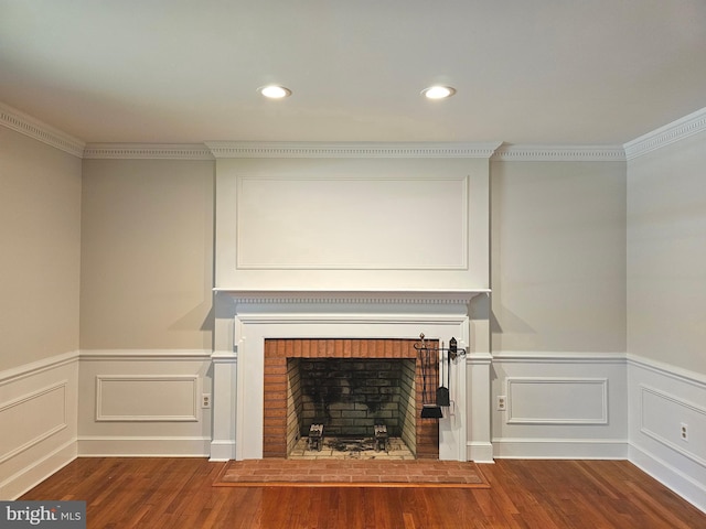 room details with ornamental molding, wood-type flooring, and a fireplace