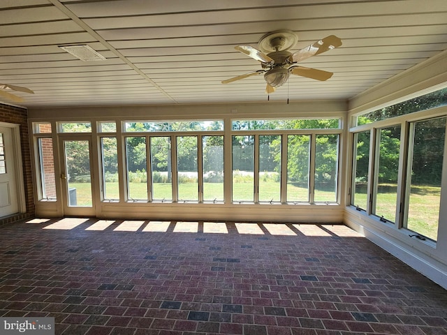 unfurnished sunroom featuring ceiling fan