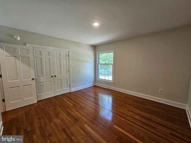 unfurnished bedroom featuring dark wood-type flooring