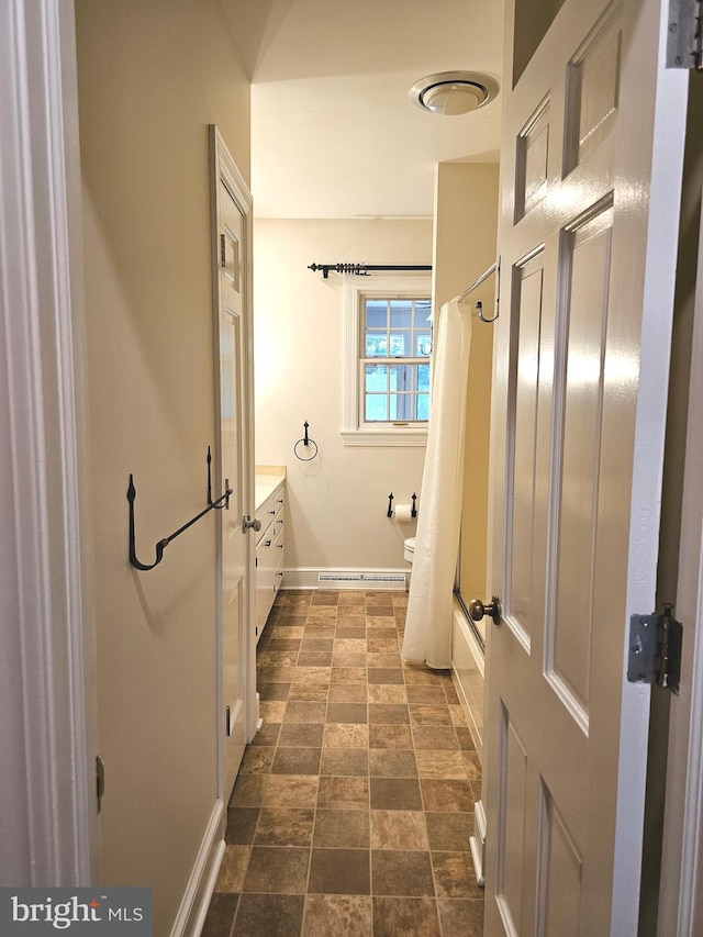 full bathroom featuring vanity, toilet, and  shower combination