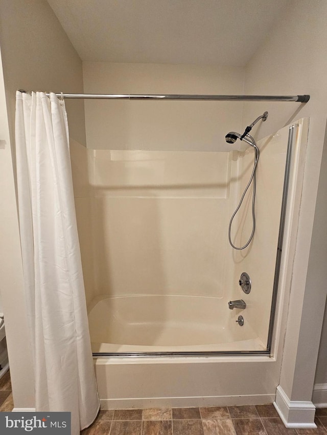 bathroom with shower / bath combination with curtain