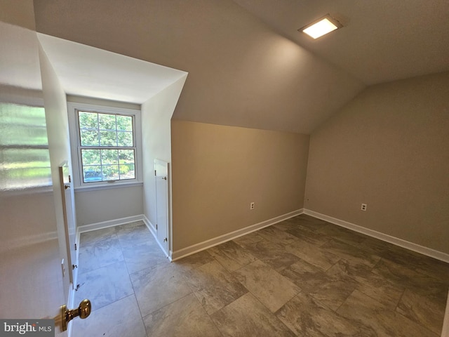 additional living space featuring vaulted ceiling