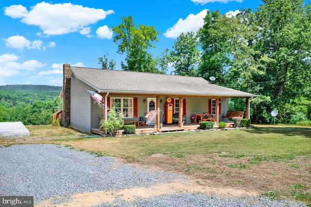 view of front of house featuring covered porch and a front lawn