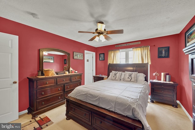 carpeted bedroom featuring a textured ceiling and ceiling fan