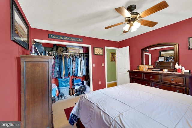 carpeted bedroom featuring a closet and ceiling fan