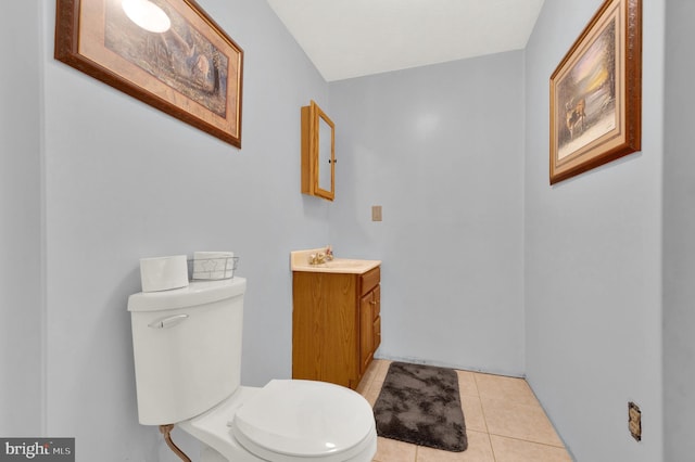 bathroom featuring tile patterned floors, vanity, and toilet