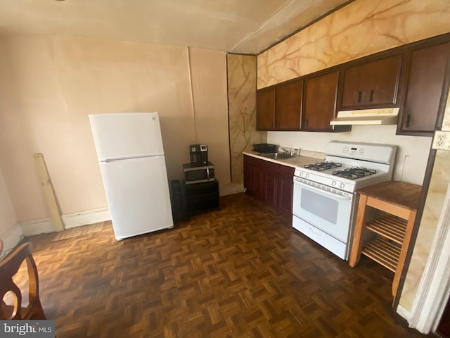 kitchen with dark parquet floors, dark brown cabinets, white appliances, and sink