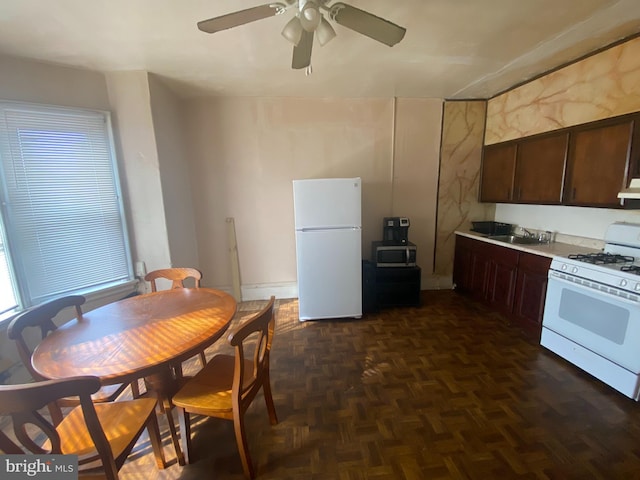 kitchen featuring dark brown cabinets, white appliances, dark parquet floors, extractor fan, and sink