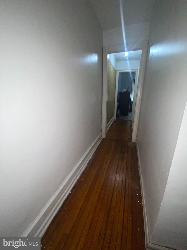 corridor featuring dark wood-type flooring