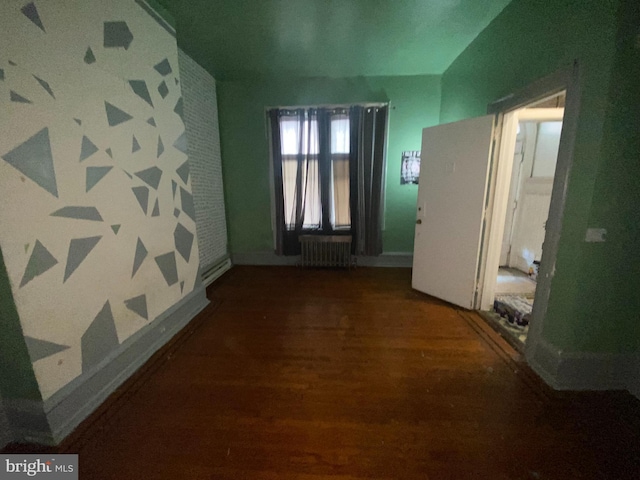 hallway featuring dark hardwood / wood-style flooring and radiator heating unit