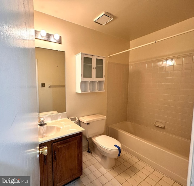 full bathroom with tile patterned flooring, vanity, tiled shower / bath combo, and toilet