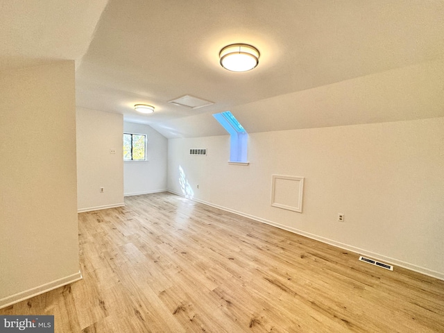 bonus room featuring light wood-type flooring and lofted ceiling