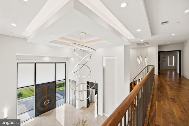 hall with dark hardwood / wood-style flooring and a tray ceiling