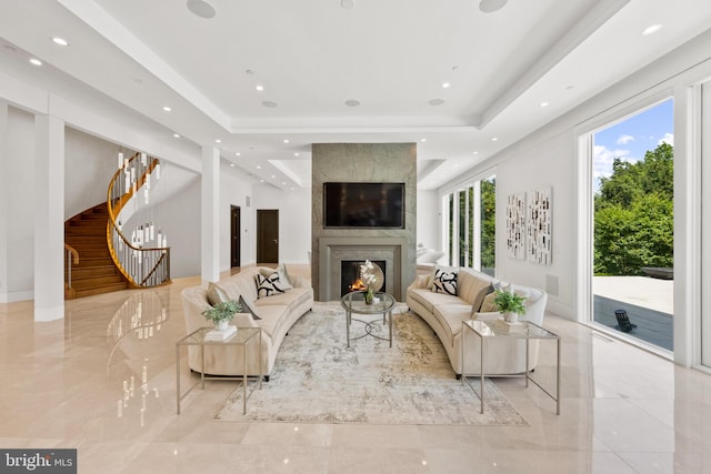 living room with a fireplace and a tray ceiling