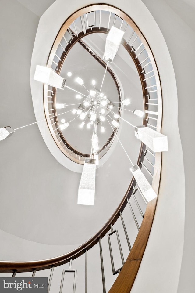 staircase with a chandelier