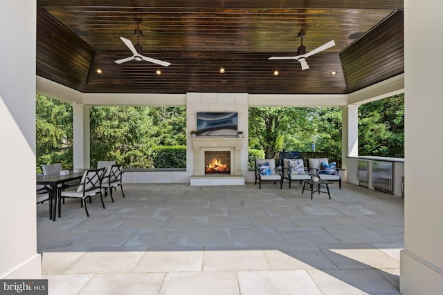 view of patio with a gazebo, ceiling fan, and an outdoor fireplace